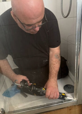 Cutting out an old shower tray during a bathroom strip-out
