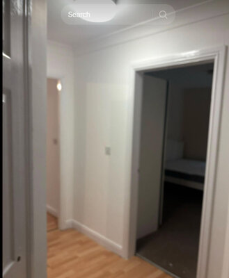Newly decorated hallway with laminate flooring in a refurbished flat