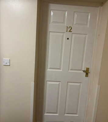 Repainted panelled flat entrance door with new ironmongery