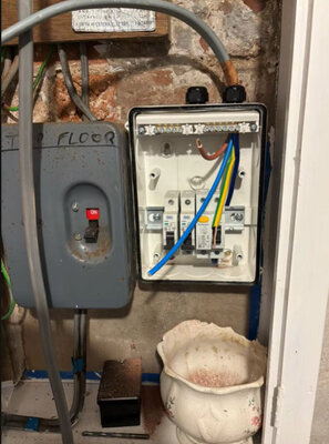 New consumer unit installed alongside an older isolator on a brick wall